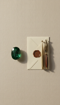 Oval-cut emerald with branded tools